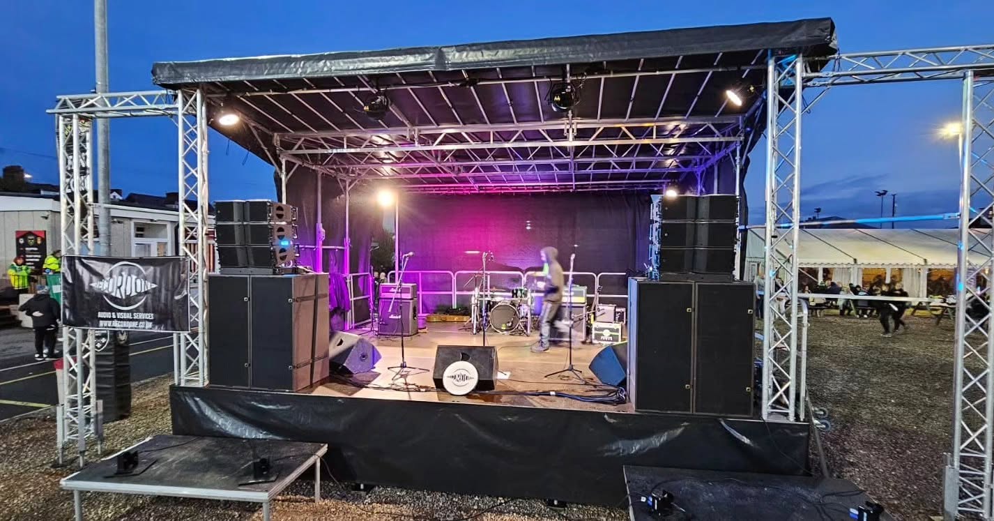 Outdoor stage at Rodney Parade with Record One PA speakers, monitors and lighting
